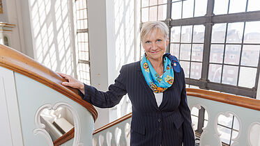 Bischöfin Kirsten Fehrs in ziviler Kleidung auf einer Seitentreppe in St. Michaelis