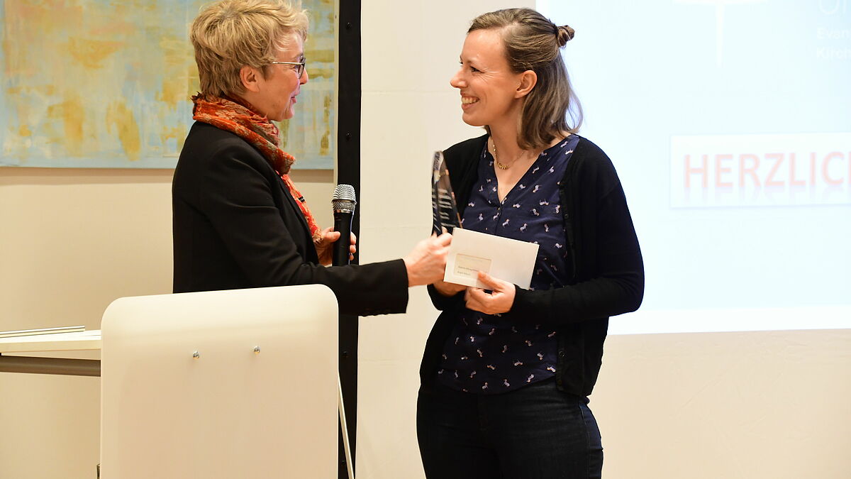 Doreen Gliemann (l.), Internetbeauftragte der Nordkirche, gratuliert Lea Krause-Solberg zum Preis für das Projekt "MitEuch! Für Kinder in Not".